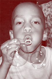 child blowing bubbles