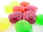 red, yellow and green hard candies on white surface