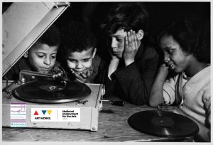 4 kids around a record player