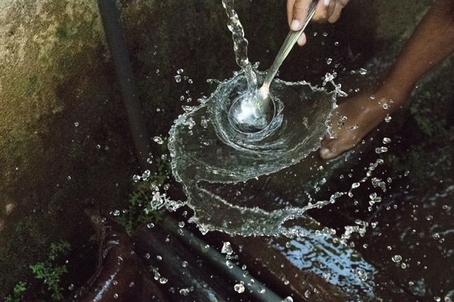 spoon splashing the surface of water